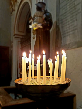 A group of sisters praying together in a peaceful chapel filled with soft candlelight.