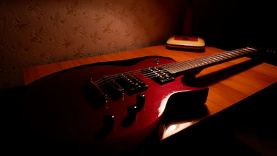 Electric guitar and harmonica resting on a rustic wooden table in the studio.