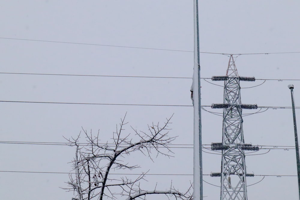 a tall tower with lots of power lines next to it