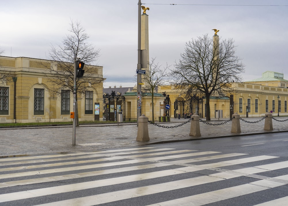 a crosswalk in front of a yellow building