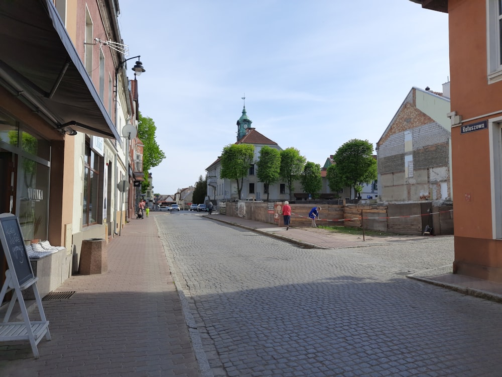 a cobblestone street with a church in the background