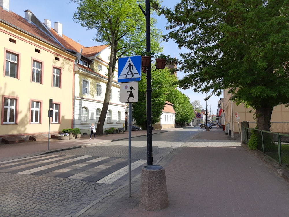 a blue and white street sign sitting on the side of a road