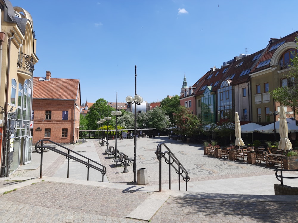 a city square with a set of stairs leading up to a restaurant