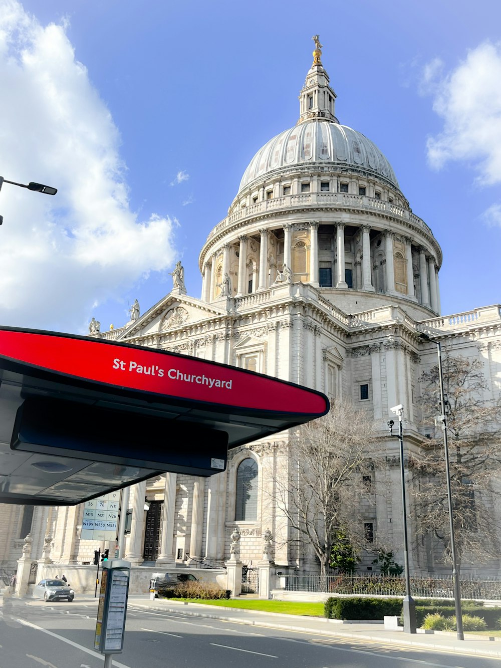 a bus stop in front of a large building