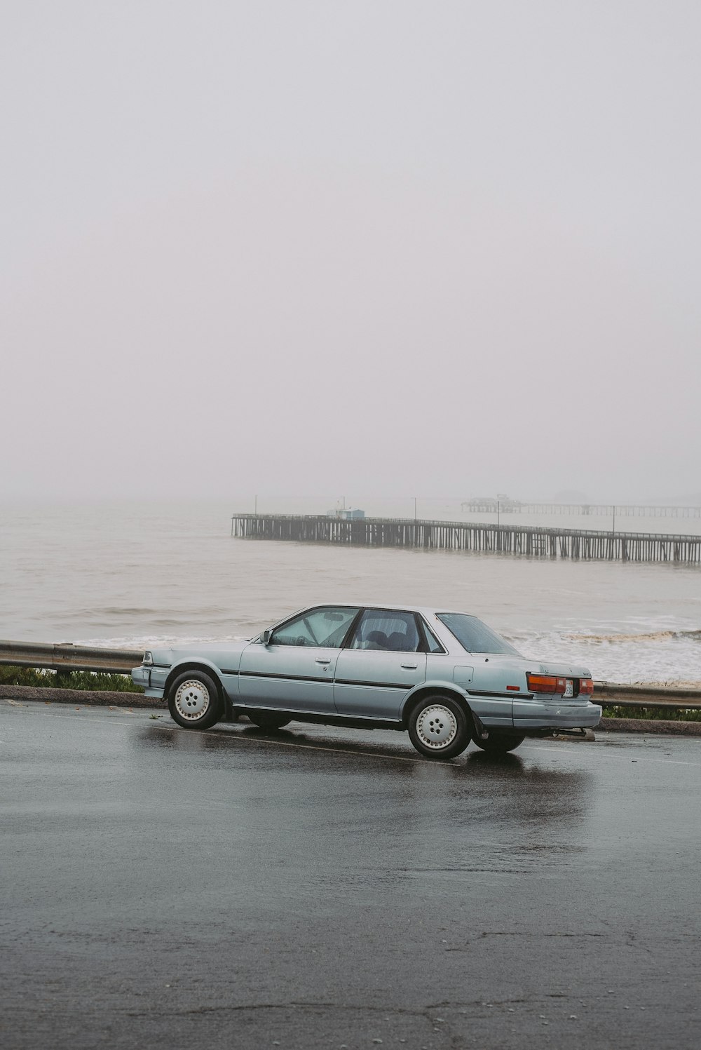 a car parked on the side of the road near the ocean