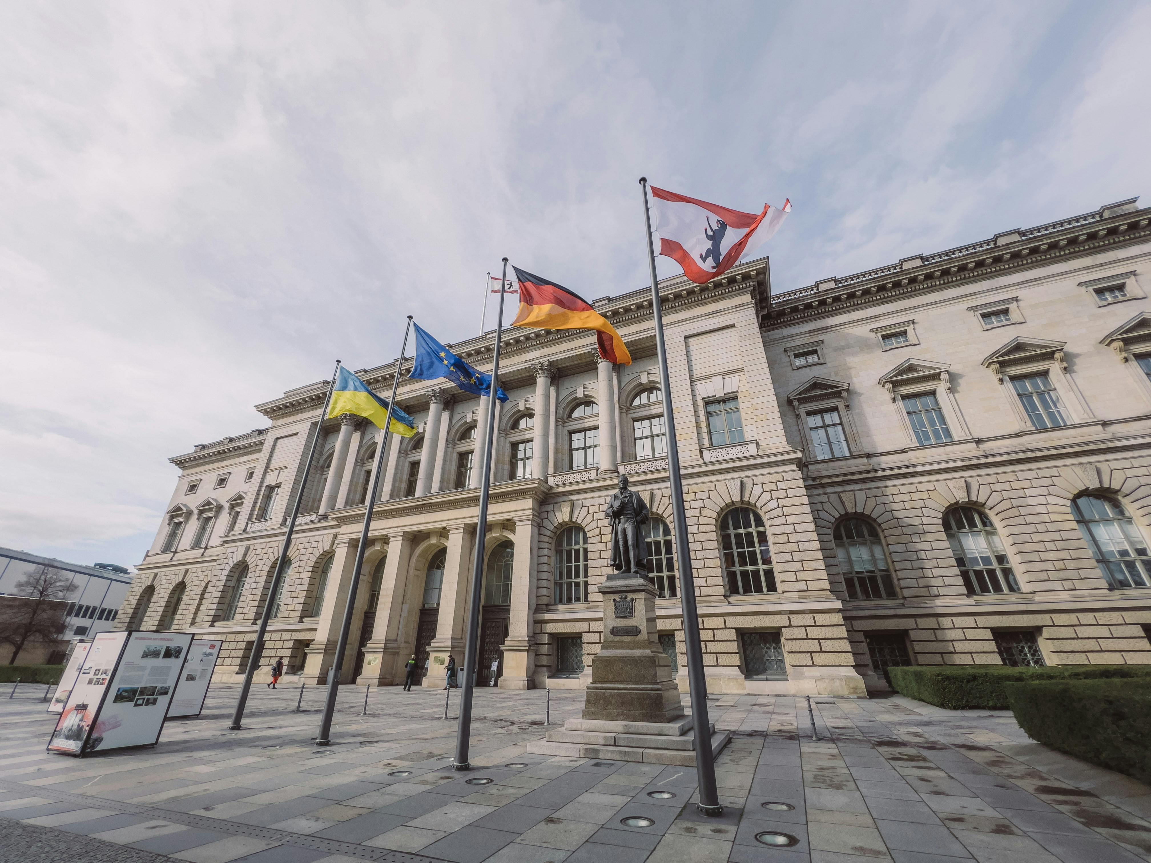 a large building with flags in front of it