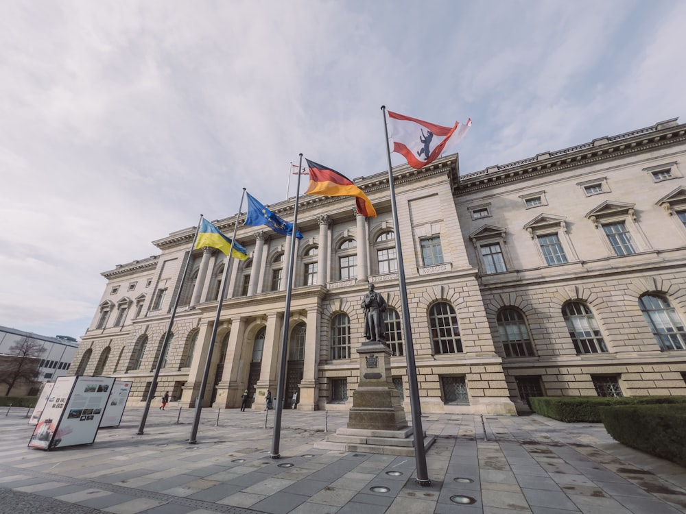 a large building with flags in front of it