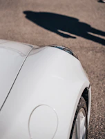 Before and after shots of a dented car fender restored to perfect condition.
