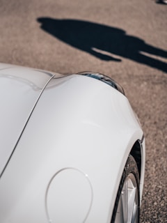 Before and after shots of a dented car fender restored to perfect condition