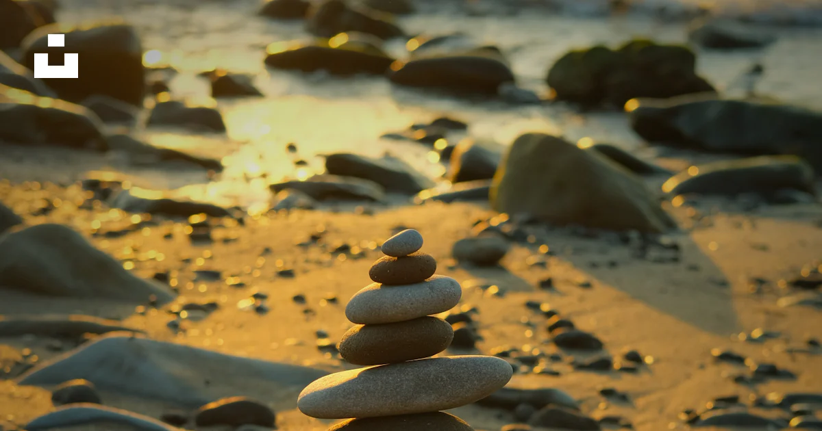 A stack of rocks sitting on top of a sandy beach photo – Free Beach ...