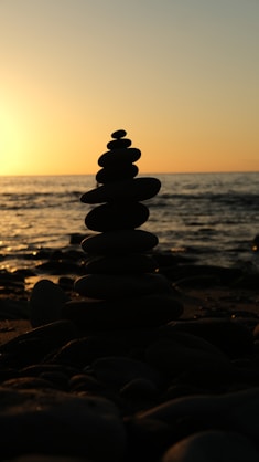 a stack of rocks sitting on top of a beach
