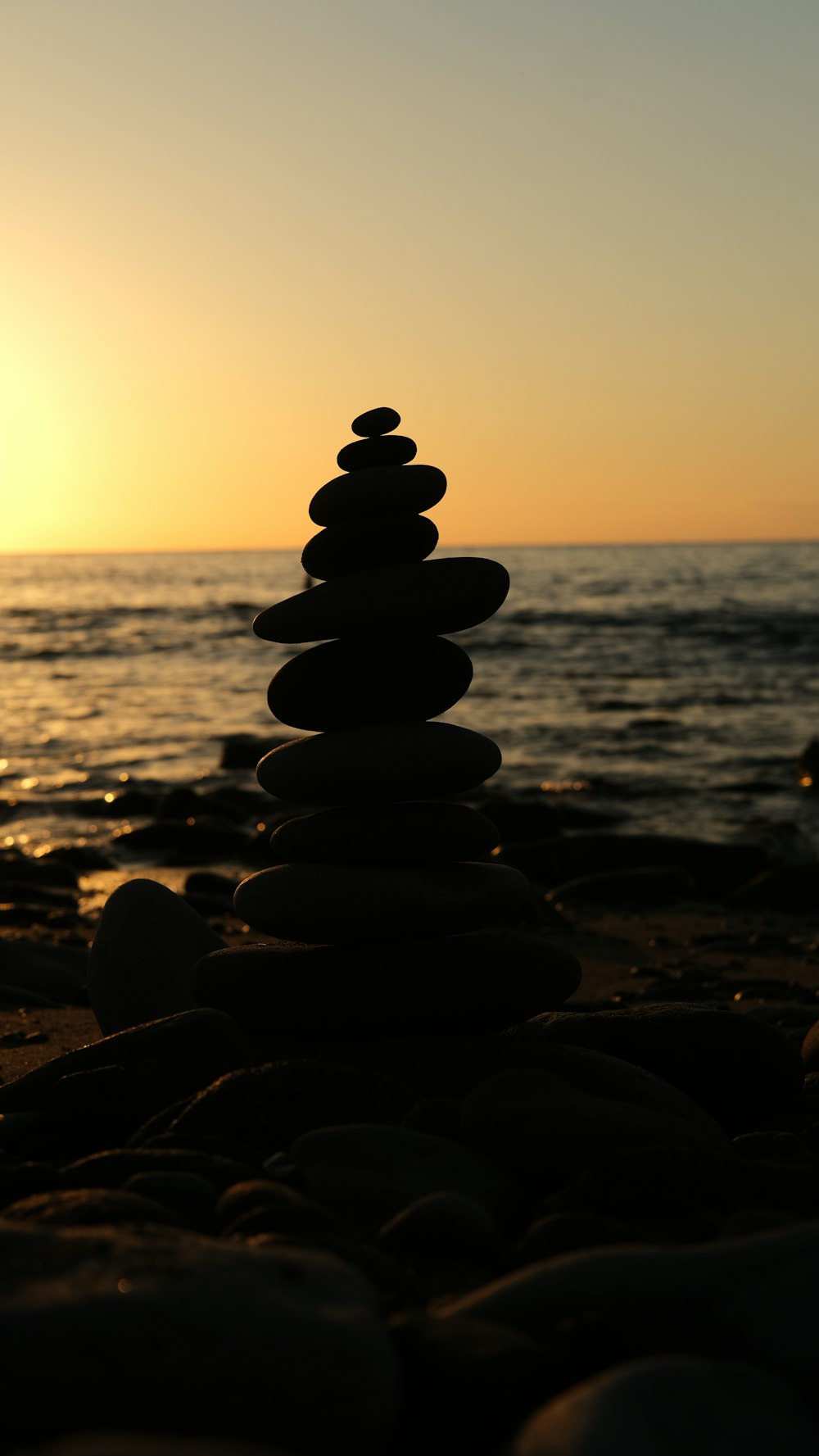 a stack of rocks sitting on top of a beach