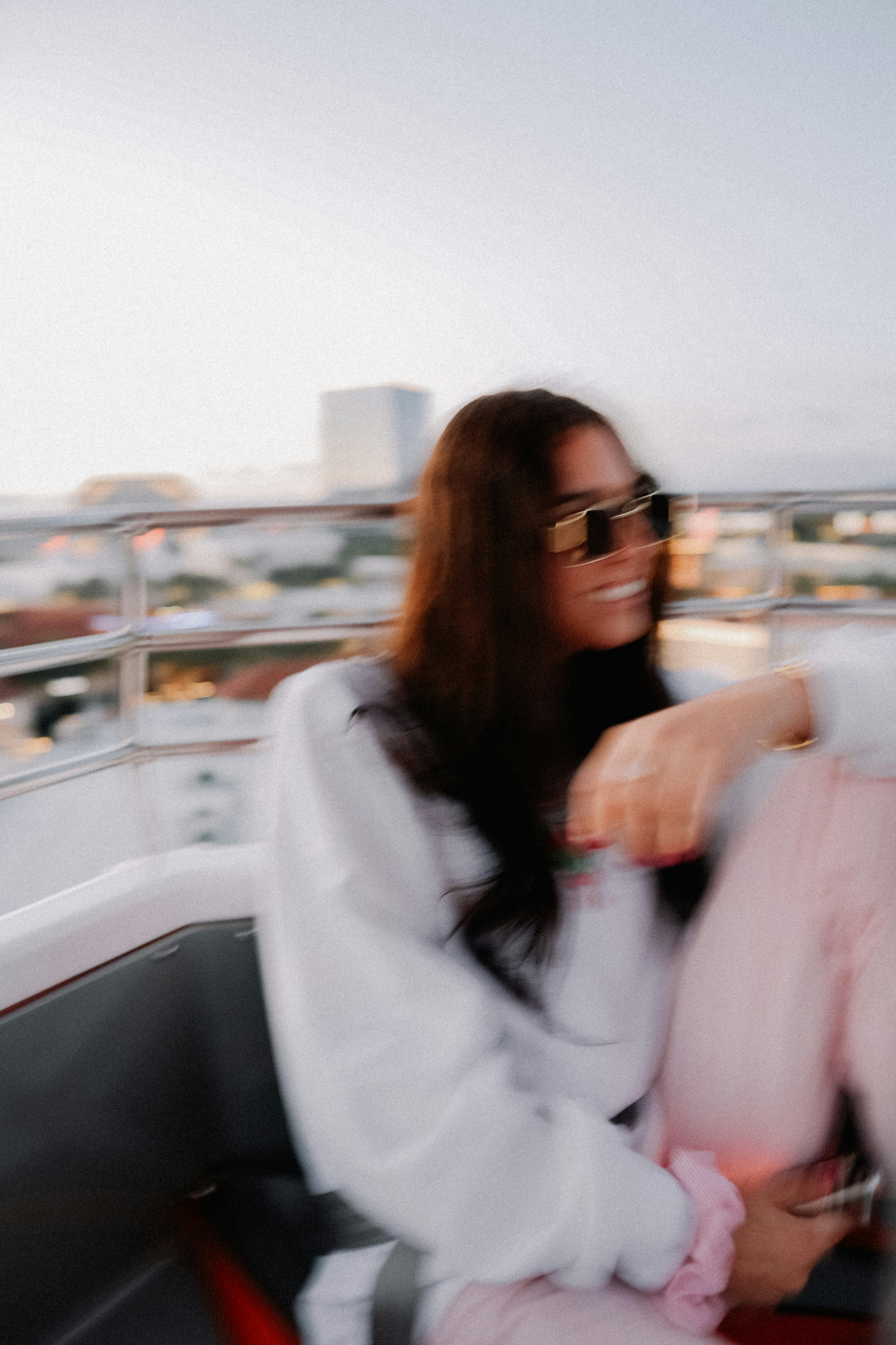 a woman sitting on top of a boat next to another woman