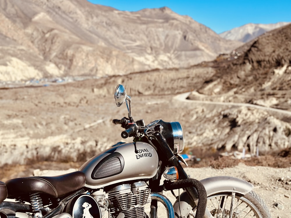 a motorcycle parked on the side of a mountain