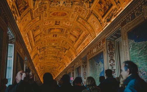 Guests admiring intricate air-painted decorations at an event.