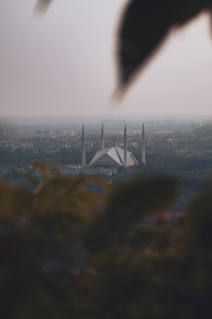Front view of Masjid Al Barakah surrounded by lush greenery in Kampung Parang.