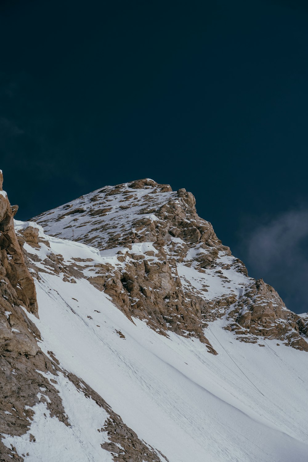 a person standing on top of a snow covered mountain