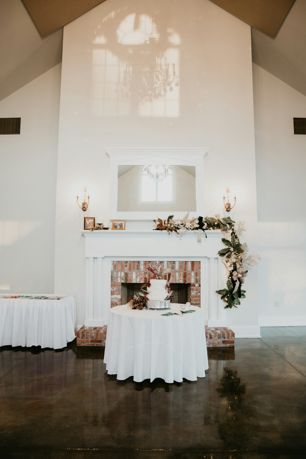 a table with a cake on it in front of a fireplace