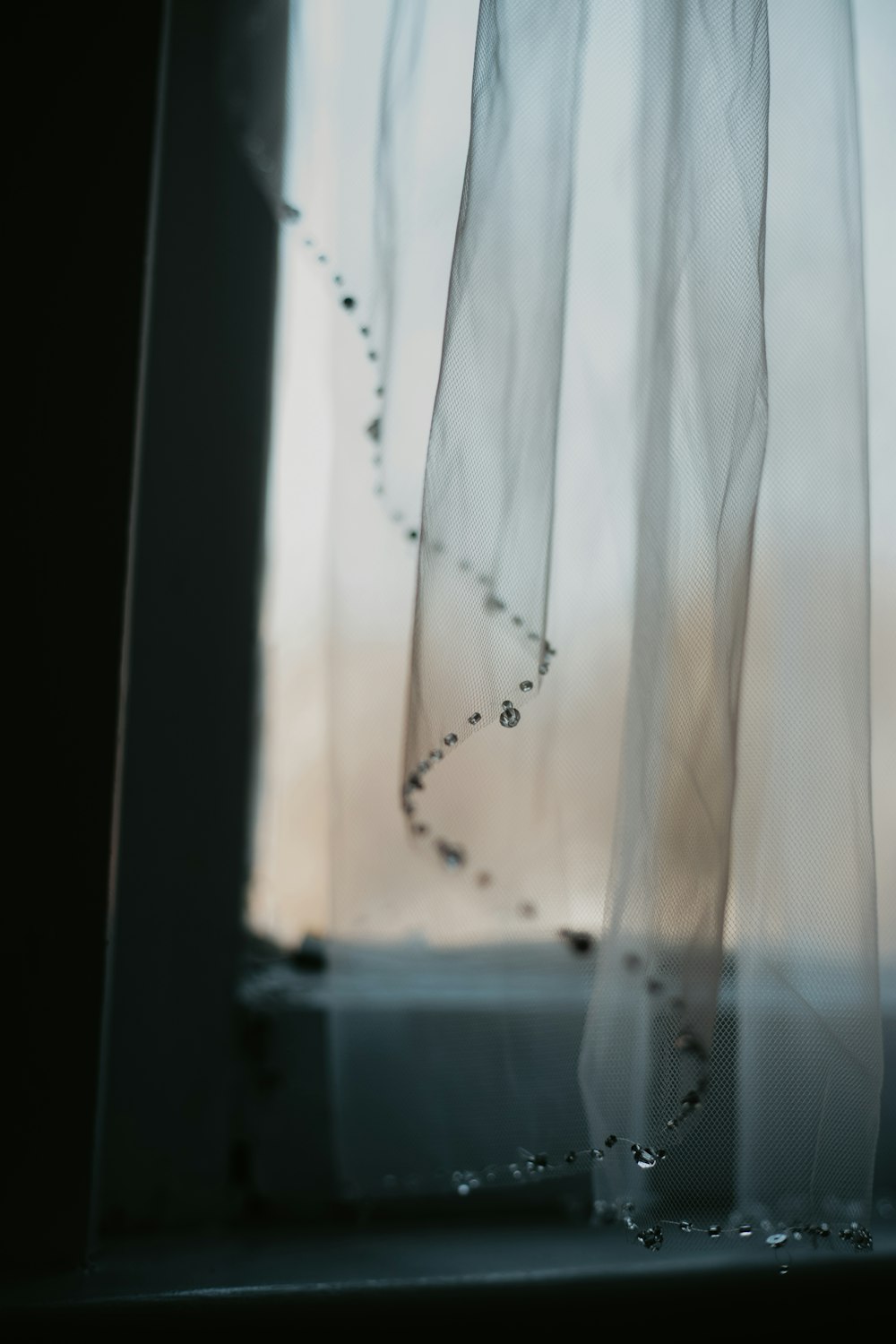 a close up of a window with a curtain