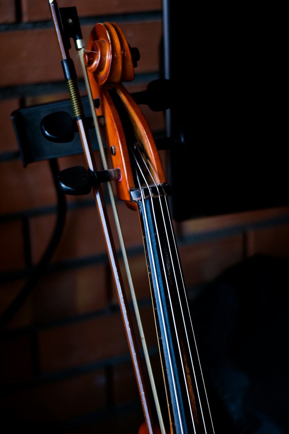 a close up of a violin on a stand
