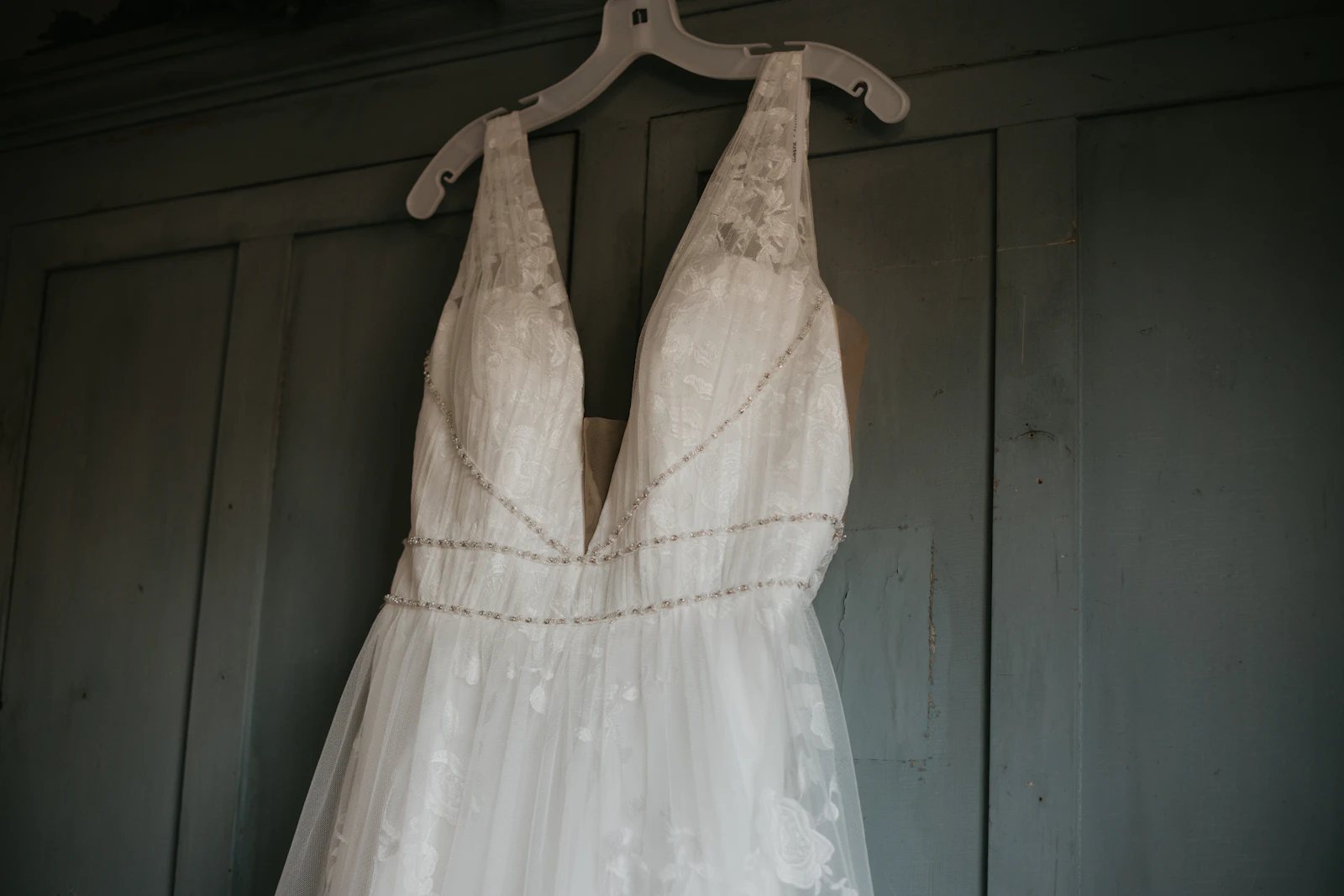 A wedding gown cared for on a hanger