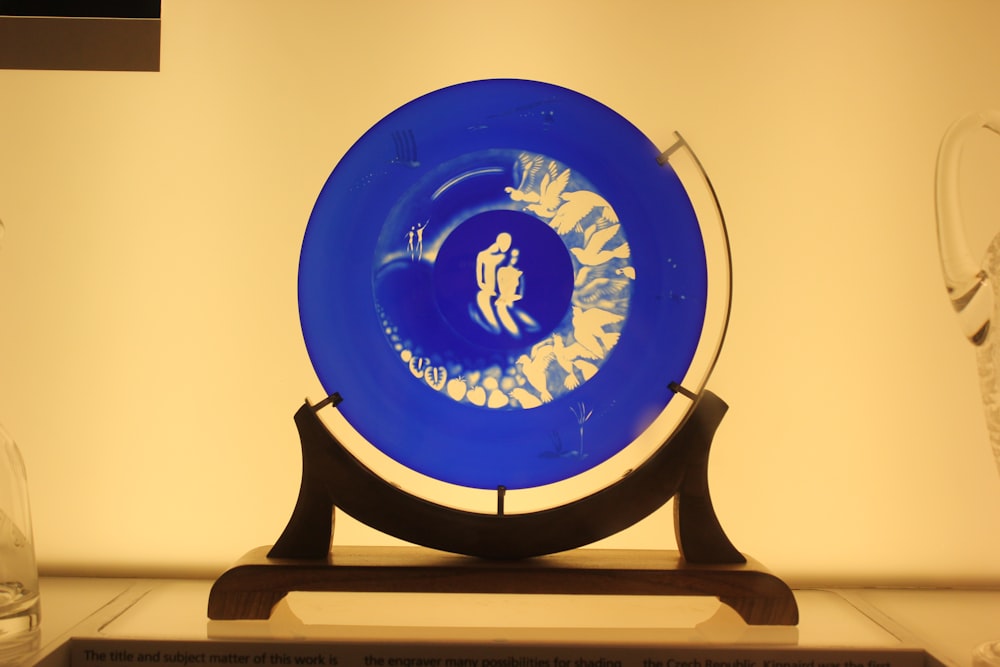 a blue frisbee sitting on top of a wooden stand