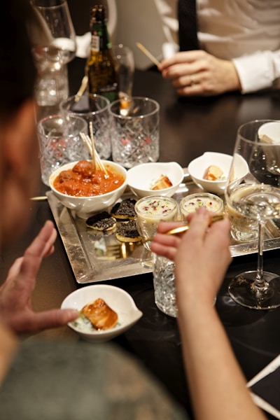 a group of people sitting around a table eating food