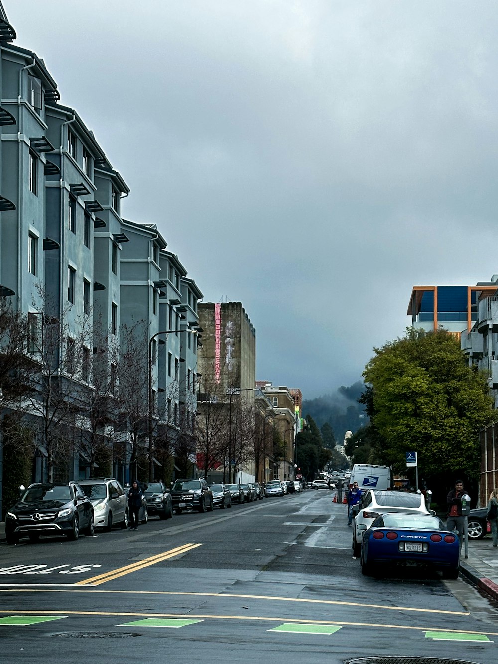 a city street with cars parked on the side of it