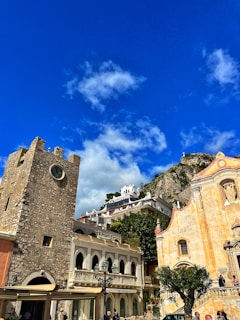 a group of buildings with a clock tower in the background