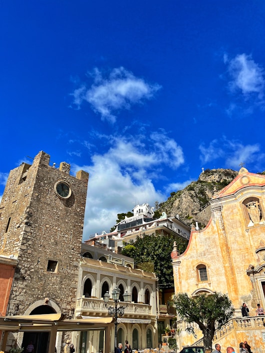 a group of buildings with a clock tower in the background