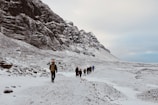 A group of friends enjoying a snowy landscape in fashionable winter gear.
