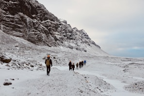A group of friends enjoying a snowy landscape in fashionable winter gear.