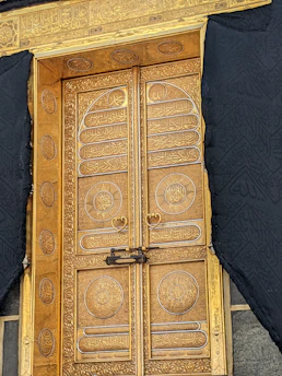 An elegant luxury security door featuring gold accents and a charcoal matte finish, highlighting premium craftsmanship.