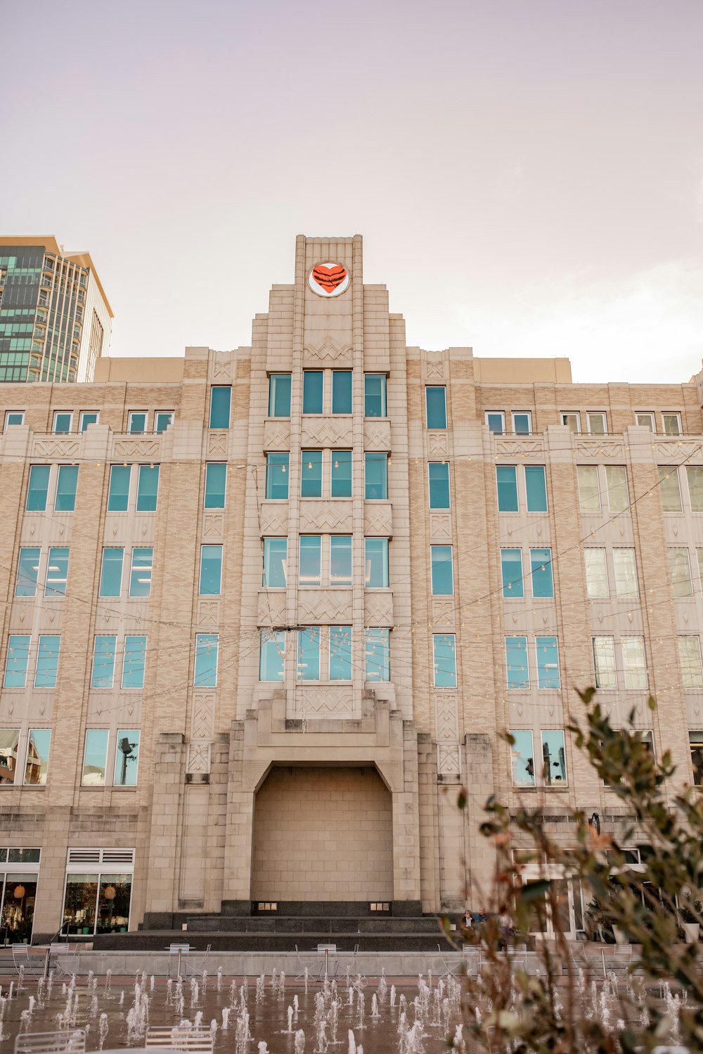 a large building with a fountain in front of it