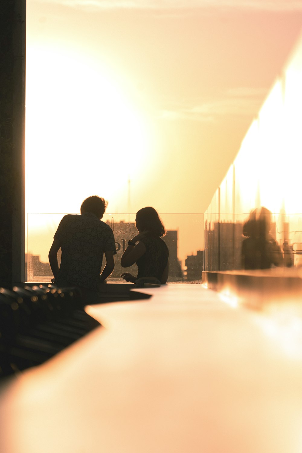 a couple of people sitting on top of a roof