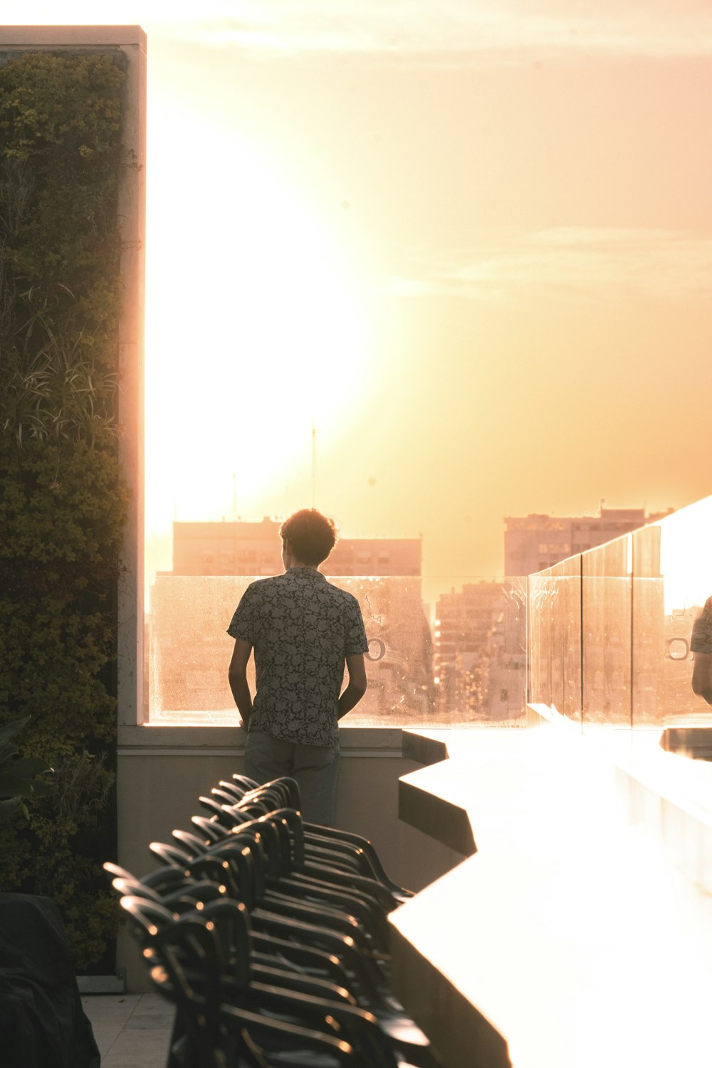 a man standing on a balcony overlooking a city