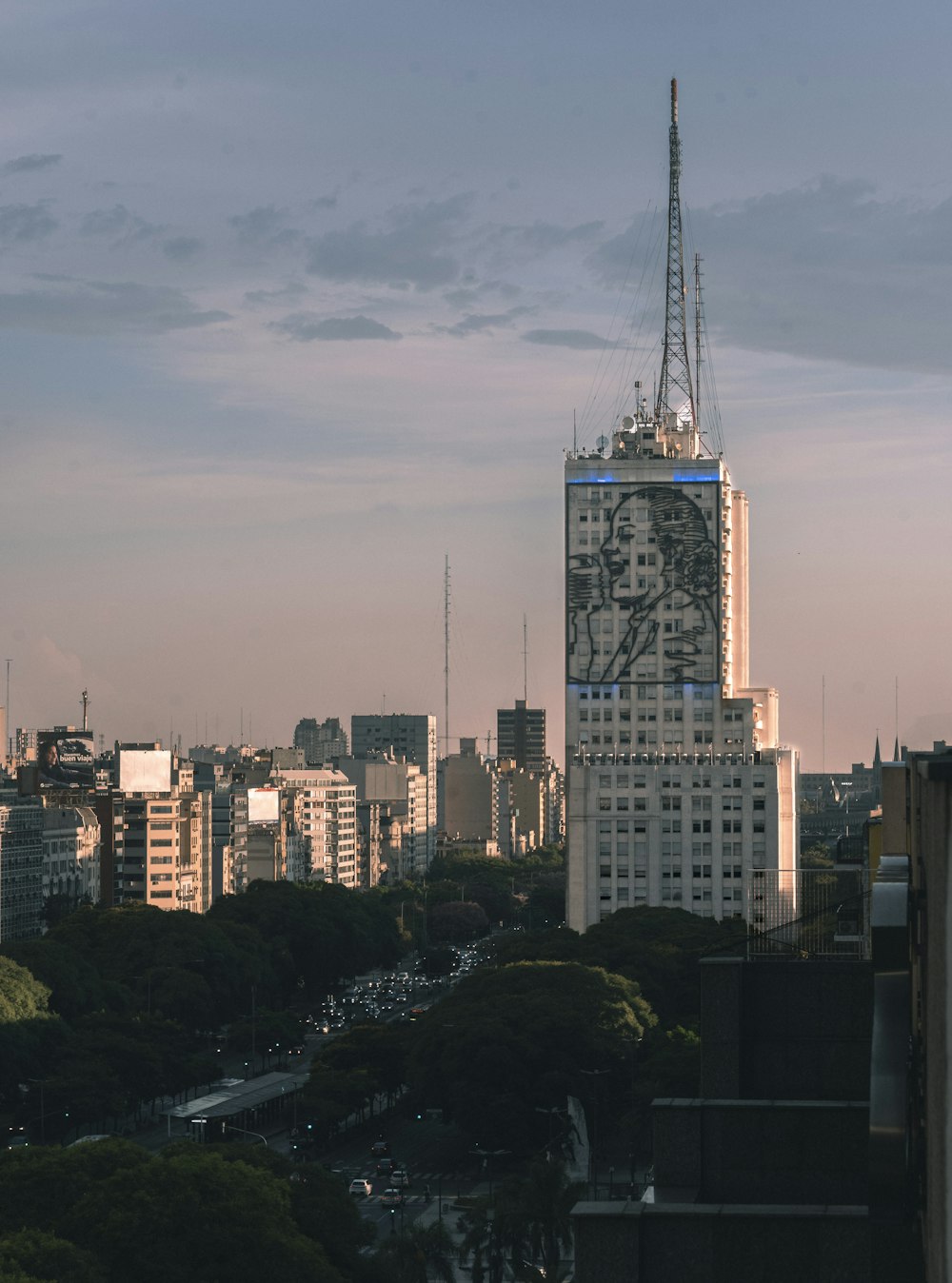 a very tall building with a lot of trees in front of it