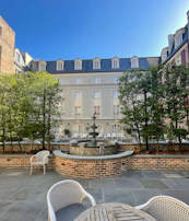 Guests enjoying a peaceful moment in a tranquil hotel courtyard garden.