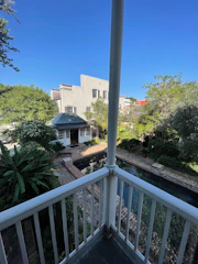 View from the studio’s balcony showing a peaceful courtyard with greenery.