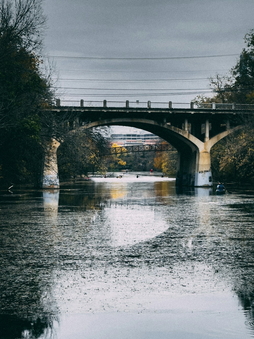 a bridge over a body of water with a boat on it