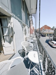 Cozy balcony overlooking a quiet residential street.