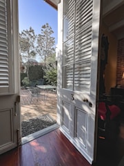Elegant aluminum sliding door opening to a sunlit patio.