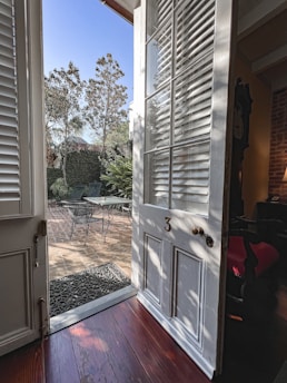 Elegant aluminum sliding door opening to a sunlit patio.