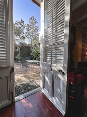 An elegant sliding door opening to a sunny terrace.
