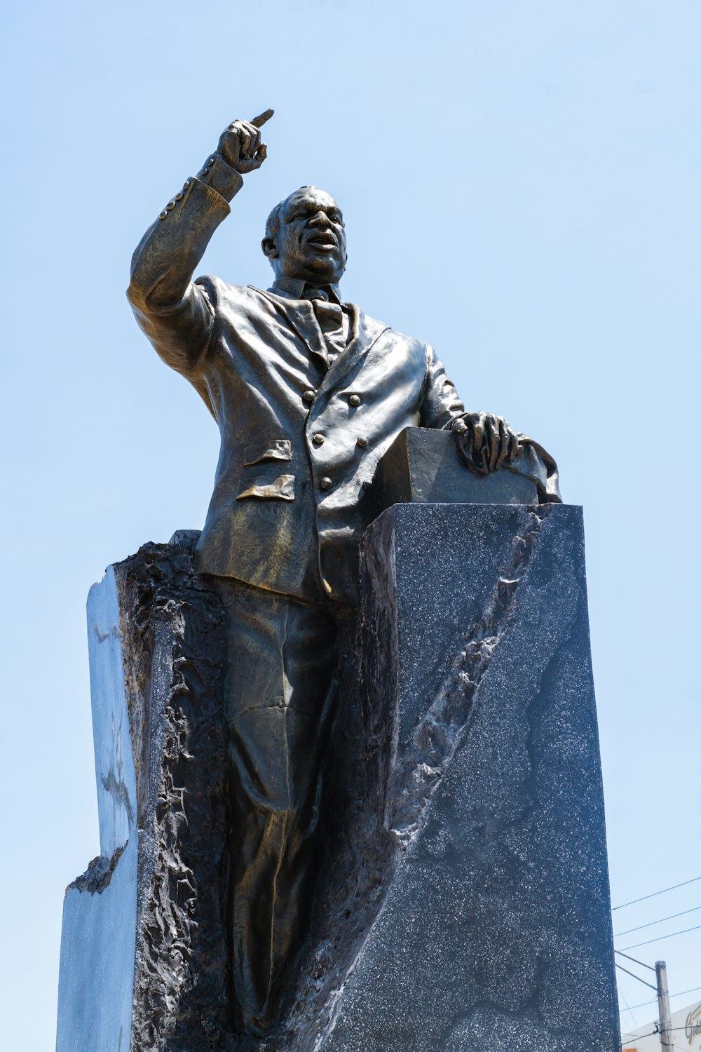 a statue of a man pointing at something