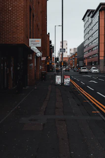A calm street scene with a 'coming soon' sign on a shop window