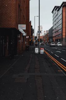 A calm street scene with a 'coming soon' sign on a shop window