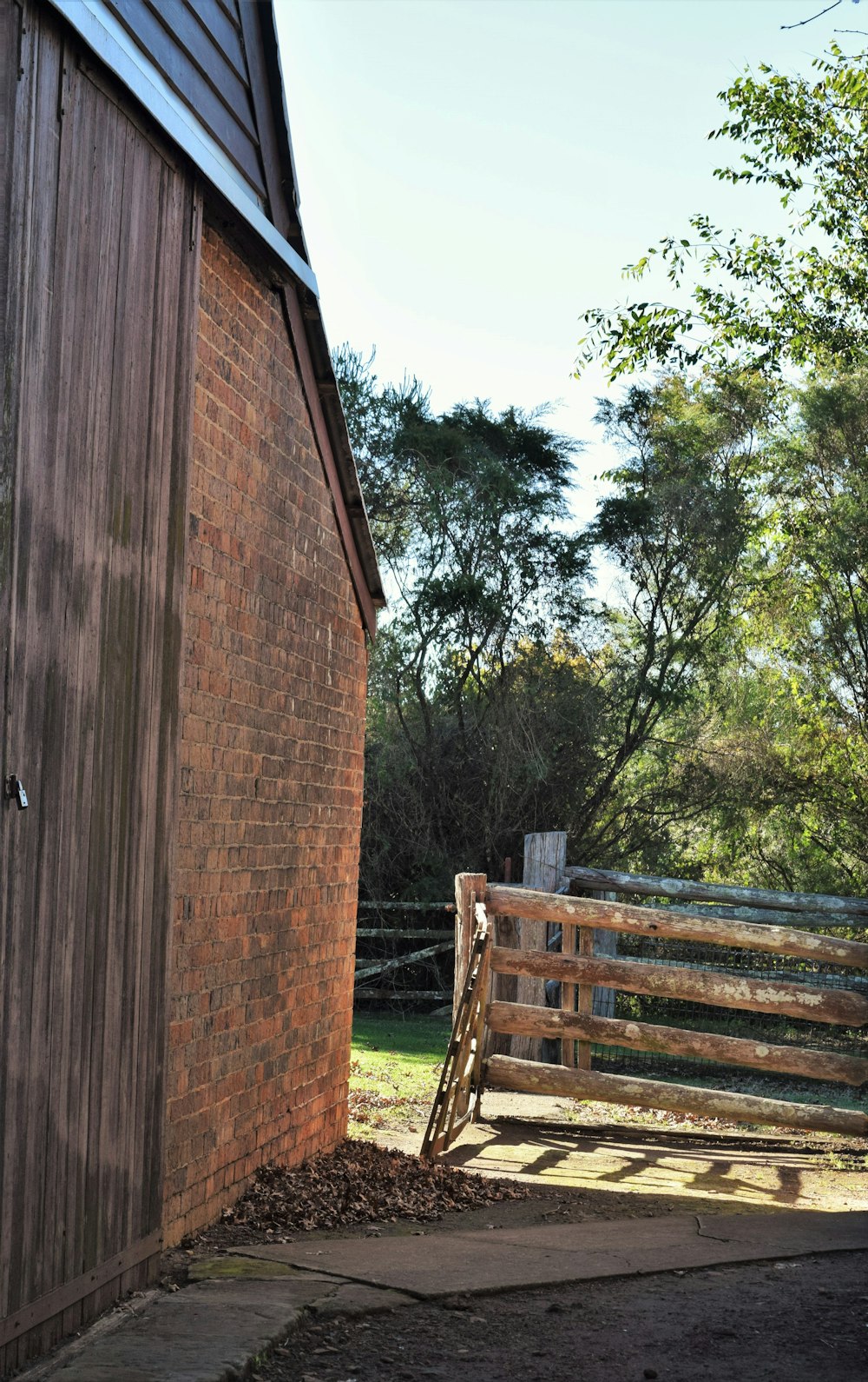 a wooden fence next to a brick building