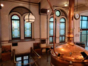 Cinematic shot of a rustic brewery with terracotta and green accents in natural light.