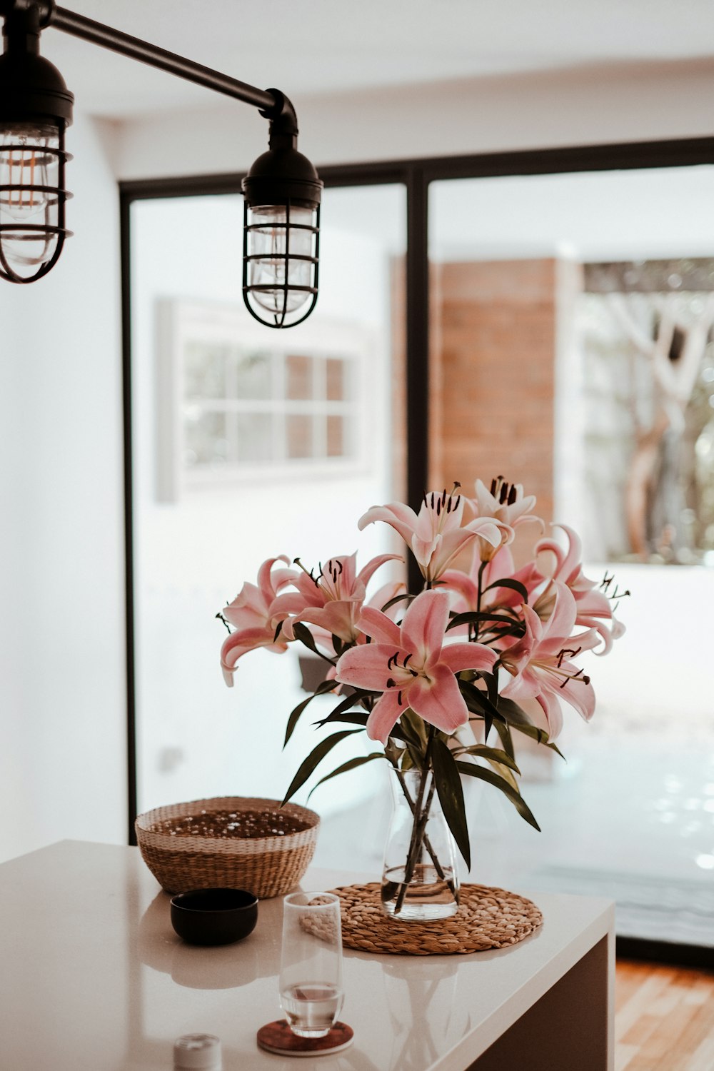 a vase filled with pink flowers sitting on top of a table